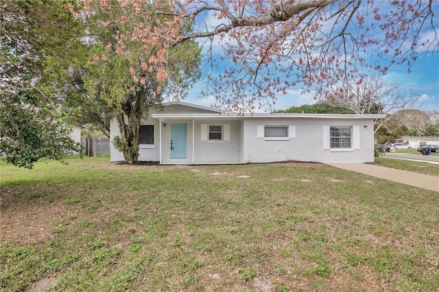 single story home featuring a front yard