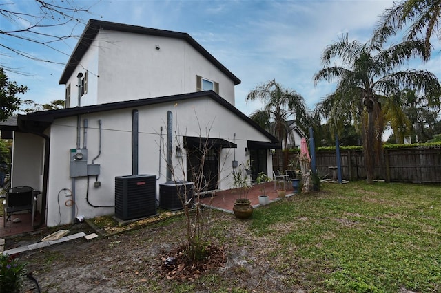 1611 Chestnut Ave, Winter Park, FL 32789 - back of house with central air condition unit, stucco siding, and a patio area