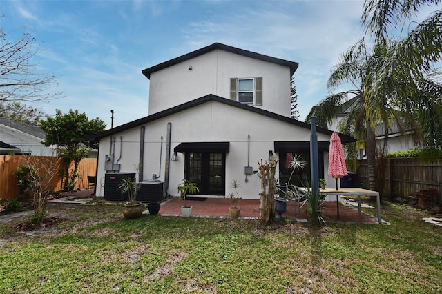 1611 Chestnut Ave, Winter Park, FL 32789 - back of property featuring stucco siding, french doors, a patio, and cooling unit
