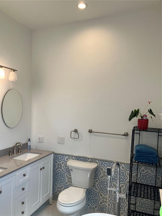 1611 Chestnut Ave, Winter Park, FL 32789 - bathroom featuring toilet, double vanity, recessed lighting, and tile patterned floors