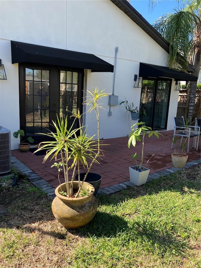1611 Chestnut Ave, Winter Park, FL 32789 - rear view of house with stucco siding, central air condition unit, and a patio area