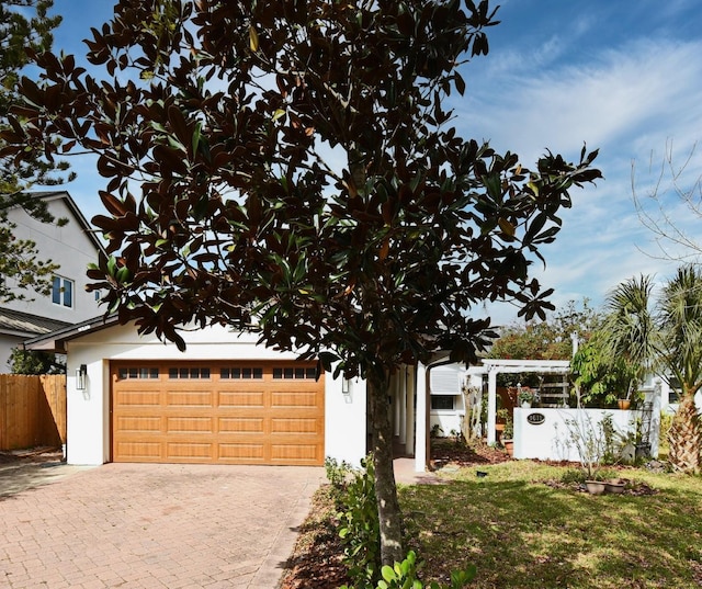 1611 Chestnut Ave, Winter Park, FL 32789 - view of front of home featuring a garage, decorative driveway, and stucco siding