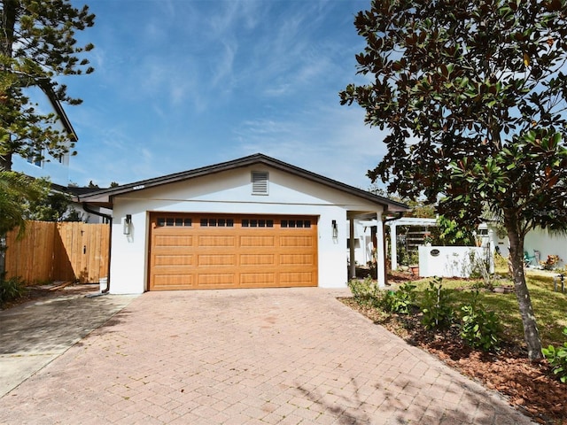 1611 Chestnut Ave, Winter Park, FL 32789 - ranch-style house with stucco siding, decorative driveway, and an attached garage