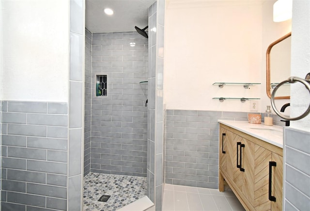 1611 Chestnut Ave, Winter Park, FL 32789 - bathroom featuring tile walls, tiled shower, vanity, wainscoting, and recessed lighting