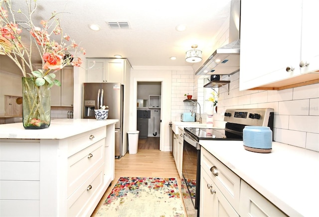 1611 Chestnut Ave, Winter Park, FL 32789 - kitchen featuring stainless steel appliances, wall chimney exhaust hood, tasteful backsplash, light countertops, and recessed lighting