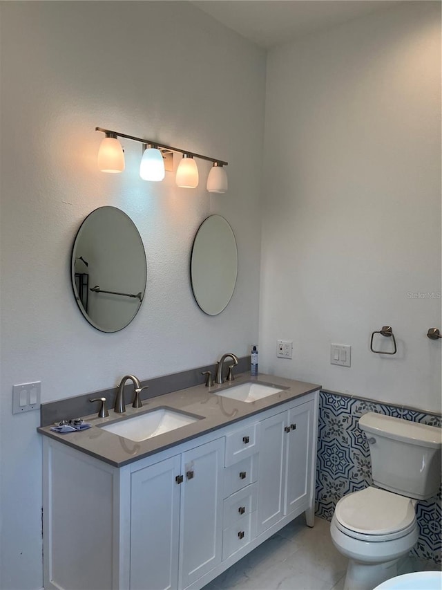 1611 Chestnut Ave, Winter Park, FL 32789 - bathroom featuring double vanity and toilet