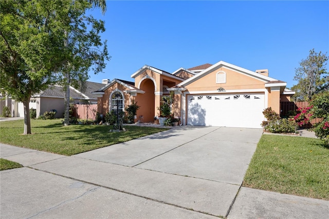 ranch-style house featuring fence, driveway, an attached garage, stucco siding, and a front lawn