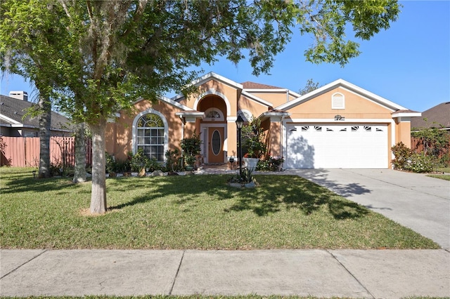 view of front of property with a front yard, a garage, driveway, and stucco siding