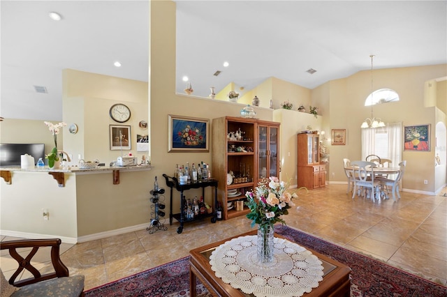 living area featuring an inviting chandelier, light tile patterned floors, baseboards, and visible vents