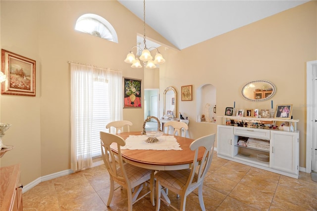 dining room with baseboards, light tile patterned flooring, arched walkways, a notable chandelier, and high vaulted ceiling