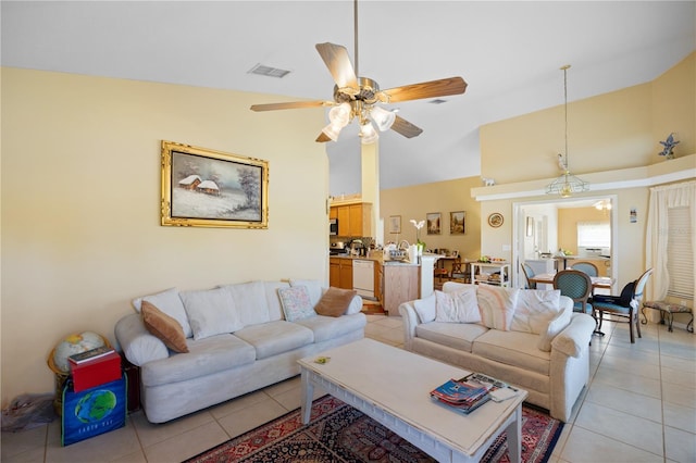 living room featuring high vaulted ceiling, light tile patterned floors, visible vents, and ceiling fan