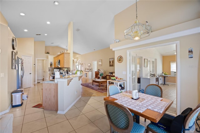 dining space featuring a notable chandelier, recessed lighting, light tile patterned floors, baseboards, and vaulted ceiling