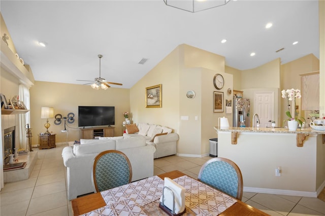 dining room with lofted ceiling, light tile patterned floors, visible vents, and ceiling fan