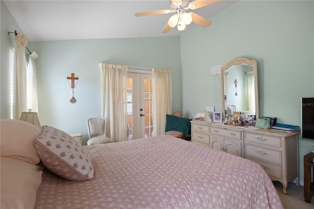 bedroom featuring lofted ceiling, multiple windows, french doors, and light colored carpet