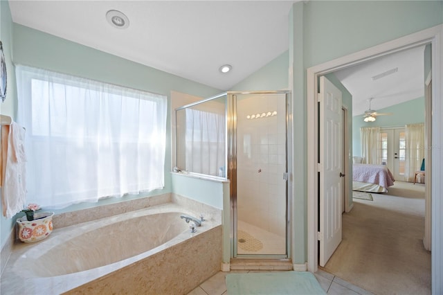 full bath featuring tile patterned floors, a bath, a shower stall, and vaulted ceiling