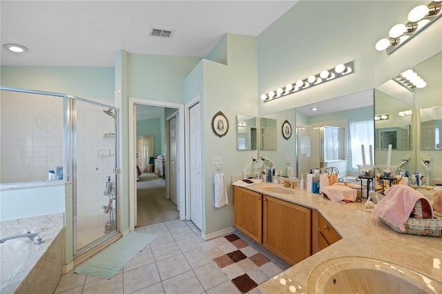 bathroom with a sink, visible vents, a garden tub, and a stall shower