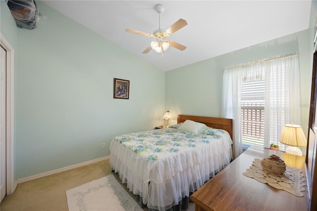 bedroom with lofted ceiling, a ceiling fan, baseboards, and light carpet