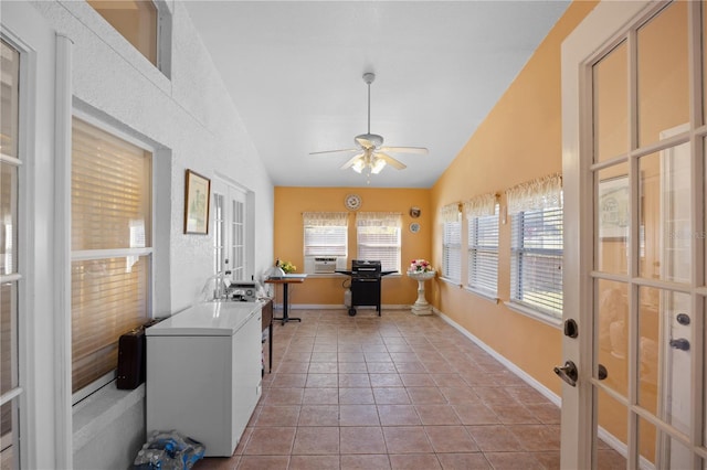 sunroom / solarium with french doors, a ceiling fan, and vaulted ceiling