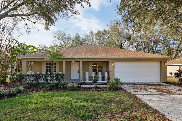 ranch-style house featuring a front lawn, a porch, and a garage