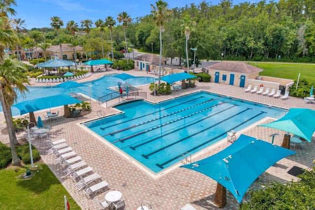 pool with a patio and fence