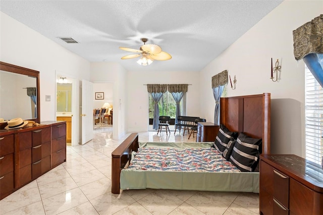 bedroom featuring visible vents, ceiling fan, and a textured ceiling