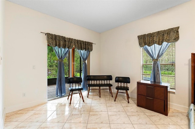 sitting room with light tile patterned flooring and baseboards