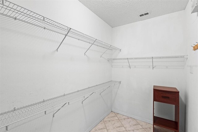 spacious closet featuring marble finish floor and visible vents