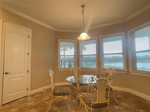 dining space featuring ornamental molding, plenty of natural light, and baseboards