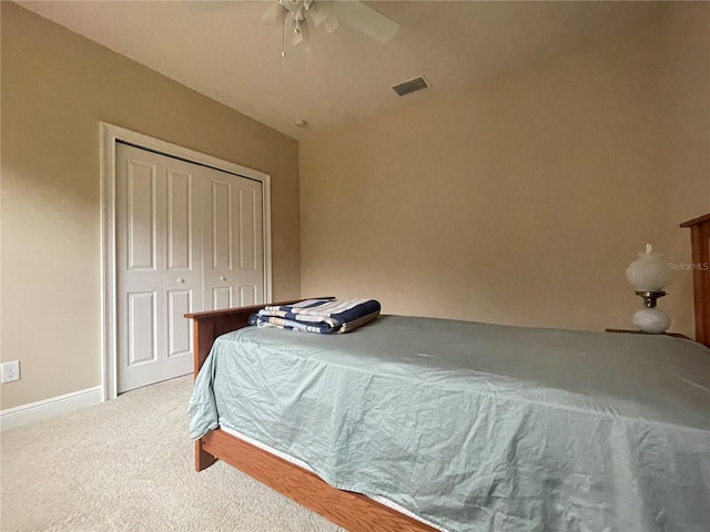 carpeted bedroom featuring visible vents, baseboards, ceiling fan, vaulted ceiling, and a closet