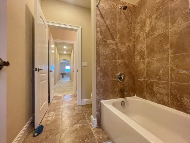 full bathroom with washtub / shower combination and baseboards