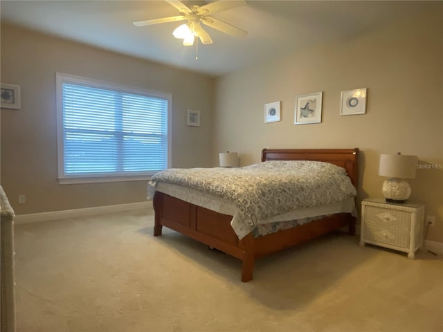 bedroom featuring light carpet, ceiling fan, and baseboards