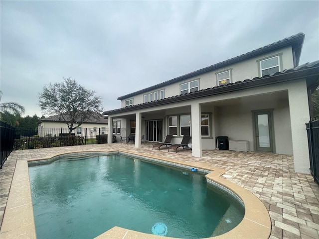 view of swimming pool with a patio, fence, and a fenced in pool