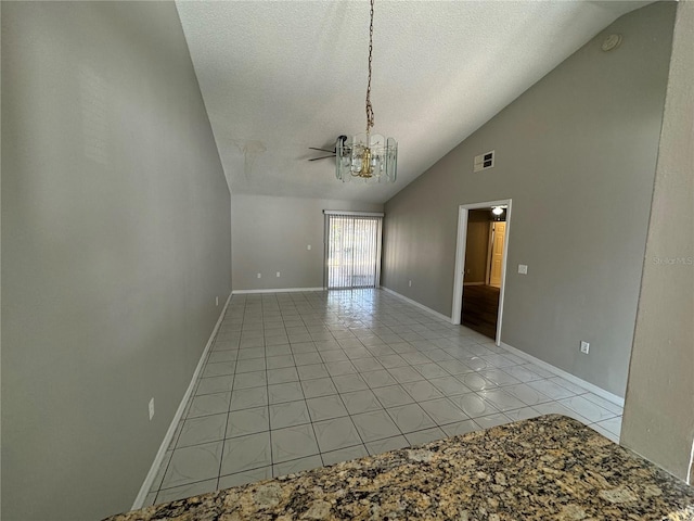 spare room with light tile patterned floors, a textured ceiling, a notable chandelier, visible vents, and baseboards