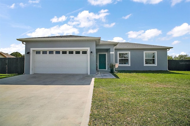 view of front of property featuring a garage and a front yard