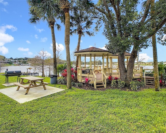 view of yard with a deck with water view and a gazebo