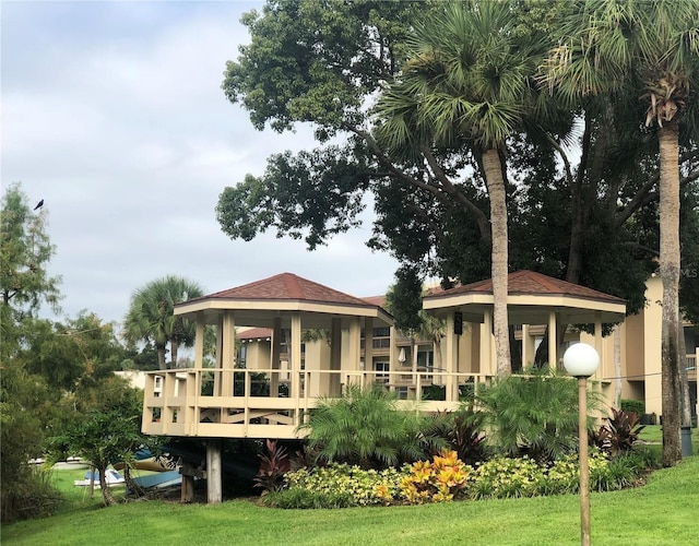 back of property featuring a lawn