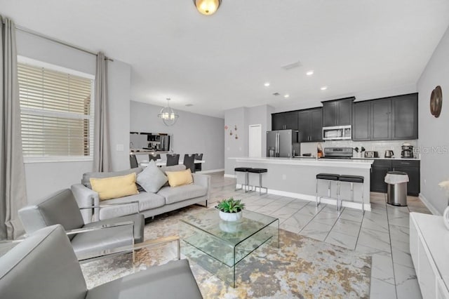 living area featuring visible vents, baseboards, marble finish floor, an inviting chandelier, and recessed lighting