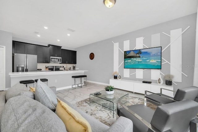 living area featuring marble finish floor, visible vents, baseboards, and recessed lighting