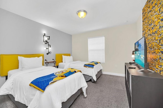 bedroom with dark colored carpet and baseboards