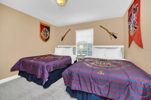 bedroom with carpet floors and baseboards