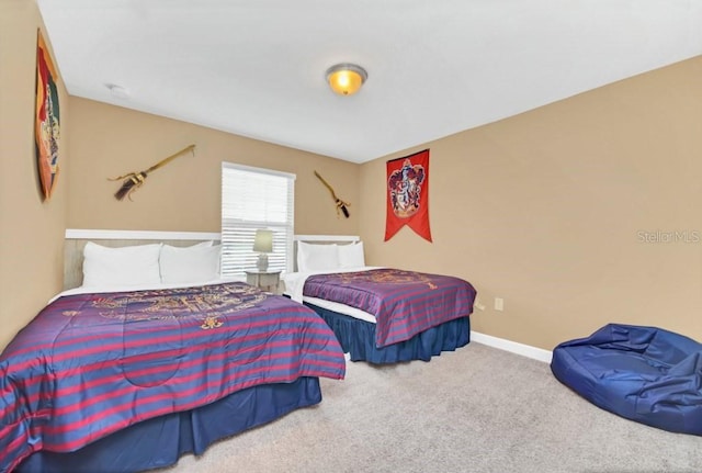 carpeted bedroom featuring baseboards