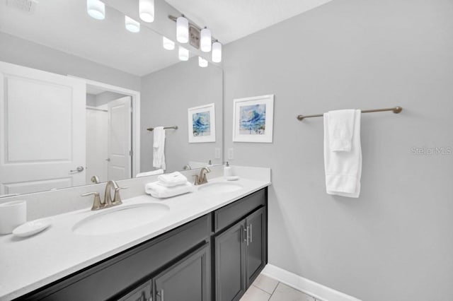 full bathroom featuring visible vents, a sink, baseboards, and double vanity