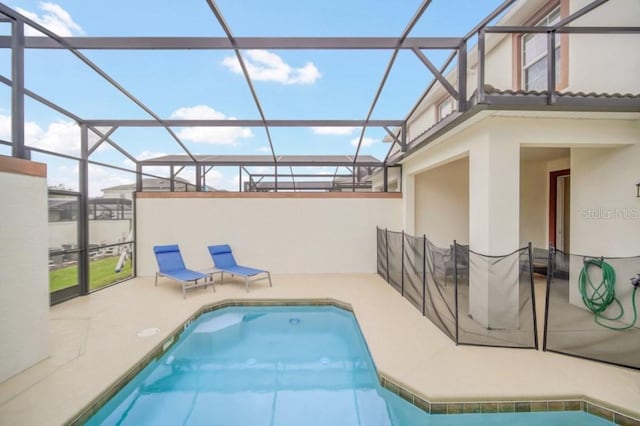 pool with a lanai and a patio area