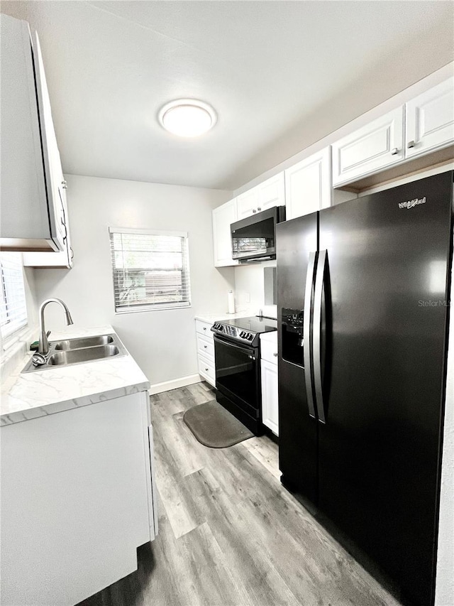 kitchen with appliances with stainless steel finishes, sink, and white cabinets