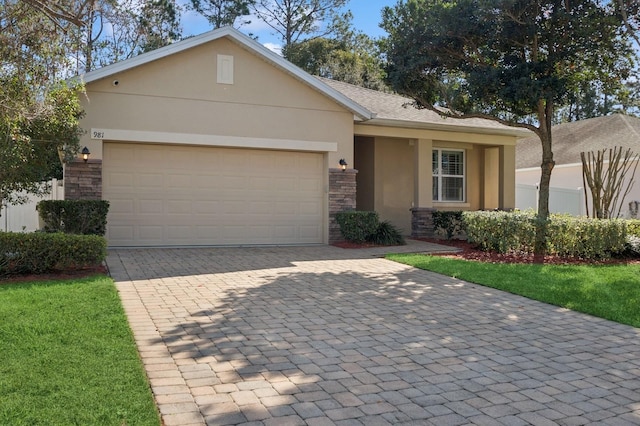 single story home featuring a garage and a front yard