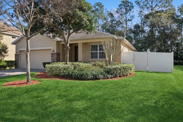 view of front of house featuring a garage and a front lawn