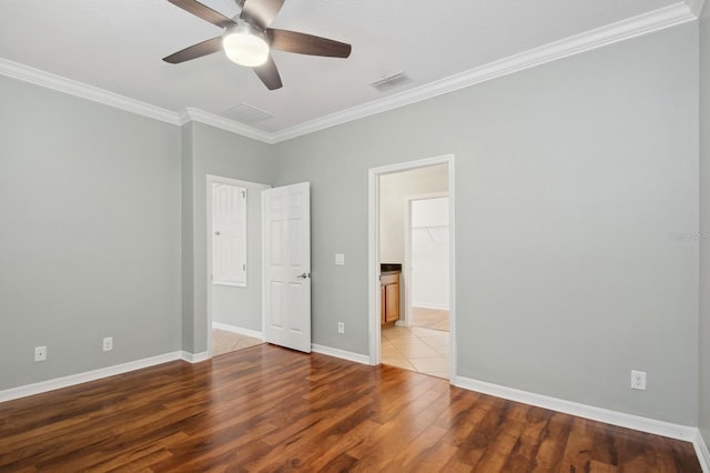 unfurnished bedroom featuring hardwood / wood-style flooring, ceiling fan, and crown molding