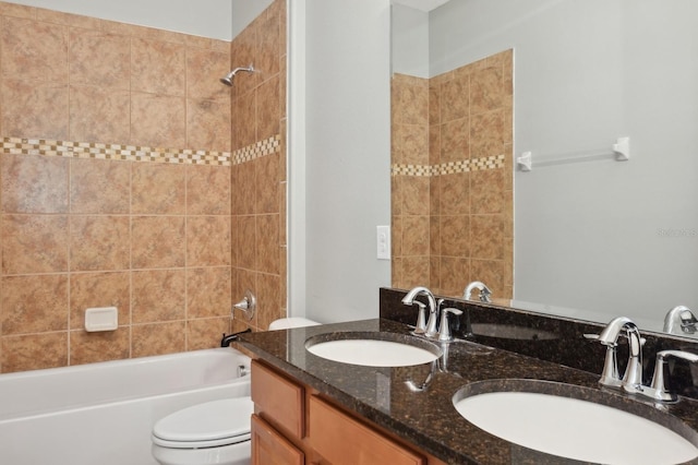 full bathroom with vanity, toilet, and tiled shower / bath