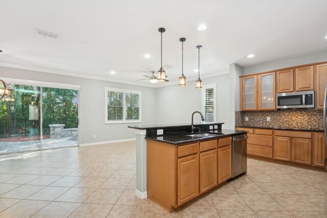 981 Galway Blvd, Apopka, FL 32703 - kitchen featuring a sink, backsplash, appliances with stainless steel finishes, and light tile patterned floors