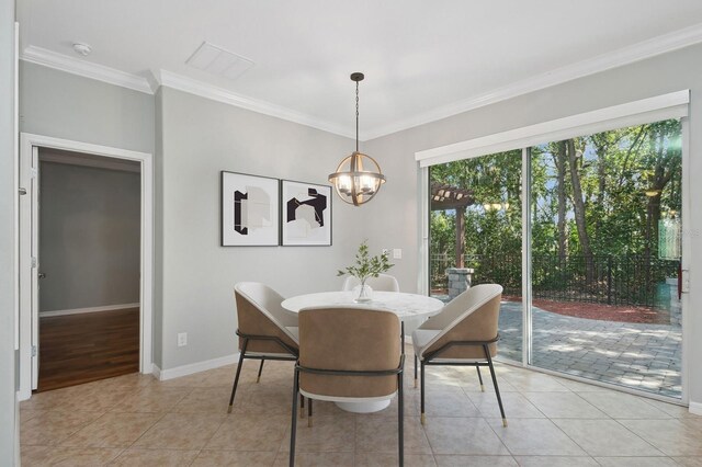 981 Galway Blvd, Apopka, FL 32703 - dining room featuring an inviting chandelier, light tile patterned floors, ornamental molding, and a wealth of natural light